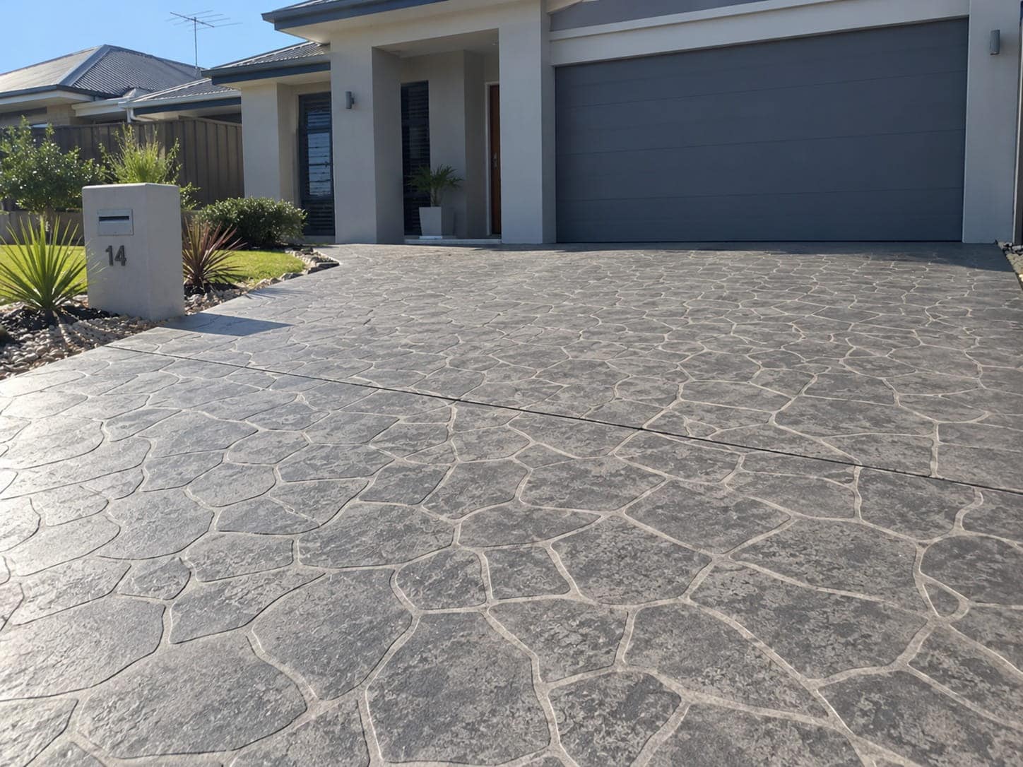 Grey crazy-paving stencilled concrete driveway at a Canberra home